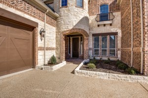 The Entry boasts beautiful stonework around the flowerbeds.